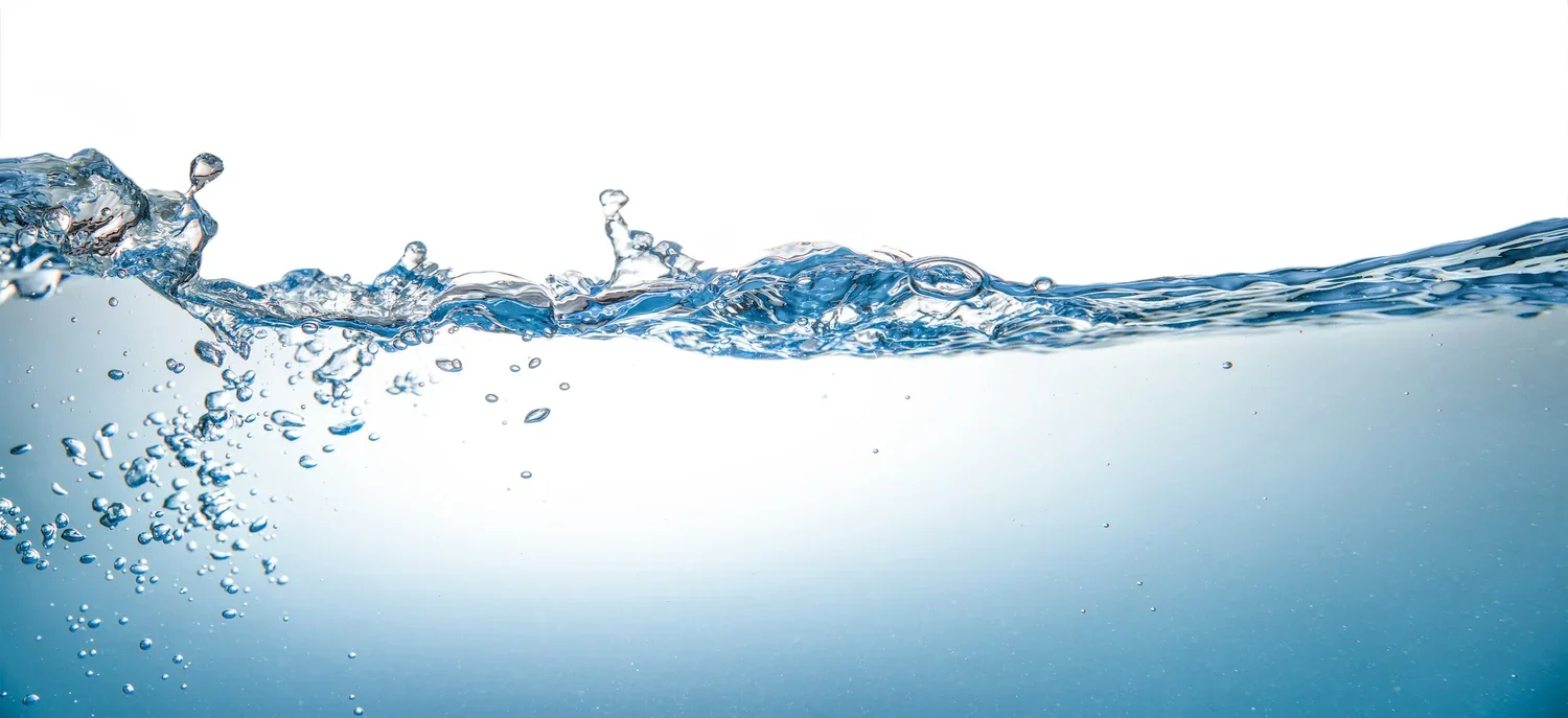Clear water splashing against a light background